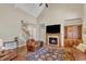 Inviting living room with fireplace, hardwood floors, and vaulted ceiling provides an elegant yet comfortable gathering space at 105 Somerley Dr, Garner, NC 27529