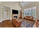 Spacious living room with a vaulted ceiling, fireplace, large windows, and hardwood floors providing natural light at 105 Somerley Dr, Garner, NC 27529