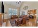 Open-concept living room featuring a fireplace, hardwood floors, vaulted ceilings, and seamless flow into the kitchen at 105 Somerley Dr, Garner, NC 27529
