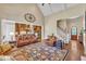Bright, open-concept living room with vaulted ceilings, hardwood floors, fireplace, and kitchen access is an entertainer's dream at 105 Somerley Dr, Garner, NC 27529
