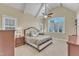 Bright main bedroom featuring vaulted ceiling, large window, and a ceiling fan at 105 Somerley Dr, Garner, NC 27529