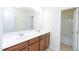 Bathroom featuring a double vanity with cherry cabinets and a shower-tub combo at 110 Elmsford St, Durham, NC 27707