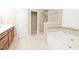 Bathroom featuring tub, shower, and tiled floor at 110 Elmsford St, Durham, NC 27707