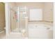 Bathroom with tub and shower featuring tiled surround at 110 Elmsford St, Durham, NC 27707