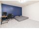 Bedroom featuring a floor bed and a desk in front of an accent wall at 110 Elmsford St, Durham, NC 27707