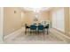 Inviting dining room featuring stylish teal chairs, a modern chandelier, and plenty of natural light at 110 Elmsford St, Durham, NC 27707