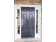 Close-up view of a stylish black front door with sidelights, set within a stone exterior at 110 Elmsford St, Durham, NC 27707