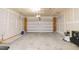 Unfinished garage with concrete floors, white sheetrock walls, and an insulated garage door at 110 Elmsford St, Durham, NC 27707