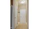 Hallway with two white doors and light tan walls and light tan flooring at 110 Elmsford St, Durham, NC 27707