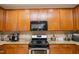 This kitchen features granite countertops, stainless steel appliances, and ample light brown cabinets at 110 Elmsford St, Durham, NC 27707