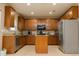 Well-lit kitchen with stainless steel appliances, granite countertops, and custom cabinetry at 110 Elmsford St, Durham, NC 27707
