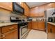 The kitchen has granite countertops, stainless steel range and microwave, and lots of cabinets at 110 Elmsford St, Durham, NC 27707
