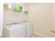 Practical laundry area with washer, dryer, and wire rack shelving for storage at 110 Elmsford St, Durham, NC 27707