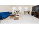 Bright living room featuring a blue velvet couch, bar table, and foosball table at 110 Elmsford St, Durham, NC 27707