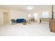 Spacious living room featuring a blue velvet couch, bar table, and foosball table at 110 Elmsford St, Durham, NC 27707