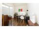Office space with hardwood flooring, a piano, and a large window at 110 Elmsford St, Durham, NC 27707