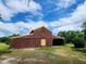 Rustic barn featuring corrugated metal siding and a quaint door on a spacious lot at 111 Matthews Mill Pond Rd, Angier, NC 27501