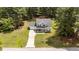 Aerial view of a lovely home with lush landscaping and a long, winding driveway at 11233 Jeffreys Ln, Wake Forest, NC 27587