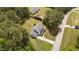 Overhead shot showcases the house with a long driveway, and lush trees surrounding the property at 11233 Jeffreys Ln, Wake Forest, NC 27587