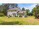 Backyard showcasing a well-maintained lawn, patio with furniture, and lush greenery, creating a relaxing outdoor space at 11233 Jeffreys Ln, Wake Forest, NC 27587