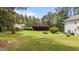 Expansive backyard with lush green grass and mature trees, offering privacy and space at 11233 Jeffreys Ln, Wake Forest, NC 27587
