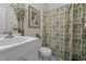 Clean bathroom features a white vanity and a patterned shower curtain at 11233 Jeffreys Ln, Wake Forest, NC 27587