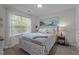 Bright bedroom with a beach-themed mural, complemented by a cozy bed, large window, and nautical decor at 11233 Jeffreys Ln, Wake Forest, NC 27587