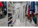 Spacious walk-in closet featuring ample shelving and storage space, adjoined bathroom at 11233 Jeffreys Ln, Wake Forest, NC 27587