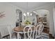 Open dining room with views to the kitchen and foyer featuring a modern chandelier at 11233 Jeffreys Ln, Wake Forest, NC 27587