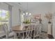 Charming dining room with natural light from large windows and elegant chandelier at 11233 Jeffreys Ln, Wake Forest, NC 27587