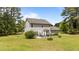 Rear exterior view of the two-story home featuring a patio with outdoor seating at 11233 Jeffreys Ln, Wake Forest, NC 27587