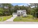Well-maintained two-story home with attached garage, beautiful landscaping, and long driveway at 11233 Jeffreys Ln, Wake Forest, NC 27587