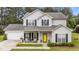 Charming two-story home with light siding, black shutters and a bright yellow front door at 11233 Jeffreys Ln, Wake Forest, NC 27587