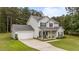 Two-story home with attached garage, well-manicured lawn, and inviting front porch at 11233 Jeffreys Ln, Wake Forest, NC 27587