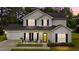 Charming two-story home with light siding, black shutters and a bright yellow front door at 11233 Jeffreys Ln, Wake Forest, NC 27587