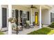 Inviting front porch with comfortable seating, plants, and a view of the home's entry at 11233 Jeffreys Ln, Wake Forest, NC 27587