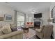 Comfortable living room with fireplace and large windows, perfect for relaxation at 11233 Jeffreys Ln, Wake Forest, NC 27587