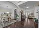 Spacious living room with elegant dining area, beautiful archways, and hardwood floors at 11233 Jeffreys Ln, Wake Forest, NC 27587