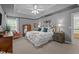 Spacious main bedroom with tray ceilings, a plush bed, and stylish decor at 11233 Jeffreys Ln, Wake Forest, NC 27587