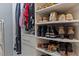 Spacious walk-in closet with custom shelving, showcasing a diverse collection of shoes and clothing at 11233 Jeffreys Ln, Wake Forest, NC 27587