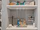 Organized walk-in closet featuring shelves displaying handbags, toiletries, and accessories in neutral tones at 11233 Jeffreys Ln, Wake Forest, NC 27587