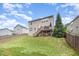 Expansive backyard featuring a wooden deck, lush lawn, and privacy fence, ideal for outdoor activities at 1211 Whispering Oak Ln, Durham, NC 27704