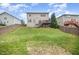 Grassy backyard with a charming deck, fenced perimeter, and a gentle slope, creating a private oasis at 1211 Whispering Oak Ln, Durham, NC 27704