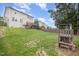 Large backyard featuring a wooden deck, playground, and well-maintained lawn, offering ample space for recreation at 1211 Whispering Oak Ln, Durham, NC 27704