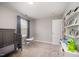 Bedroom with a crib, toys, a table and chairs, and a large window at 1211 Whispering Oak Ln, Durham, NC 27704
