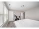 Bedroom featuring a workout bike, large windows, and white walls at 1211 Whispering Oak Ln, Durham, NC 27704