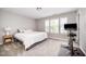 Bright bedroom featuring a workout bike, large windows, and neutral decor at 1211 Whispering Oak Ln, Durham, NC 27704
