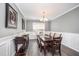 Formal dining room with seating for six, accented by modern chandelier and wainscoting at 1211 Whispering Oak Ln, Durham, NC 27704