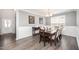 Elegant dining room with hardwood floors, wainscoting, and a chandelier above the table at 1211 Whispering Oak Ln, Durham, NC 27704