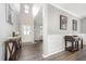 Welcoming foyer with high ceilings, elegant lighting, and beautiful dark wood floors at 1211 Whispering Oak Ln, Durham, NC 27704